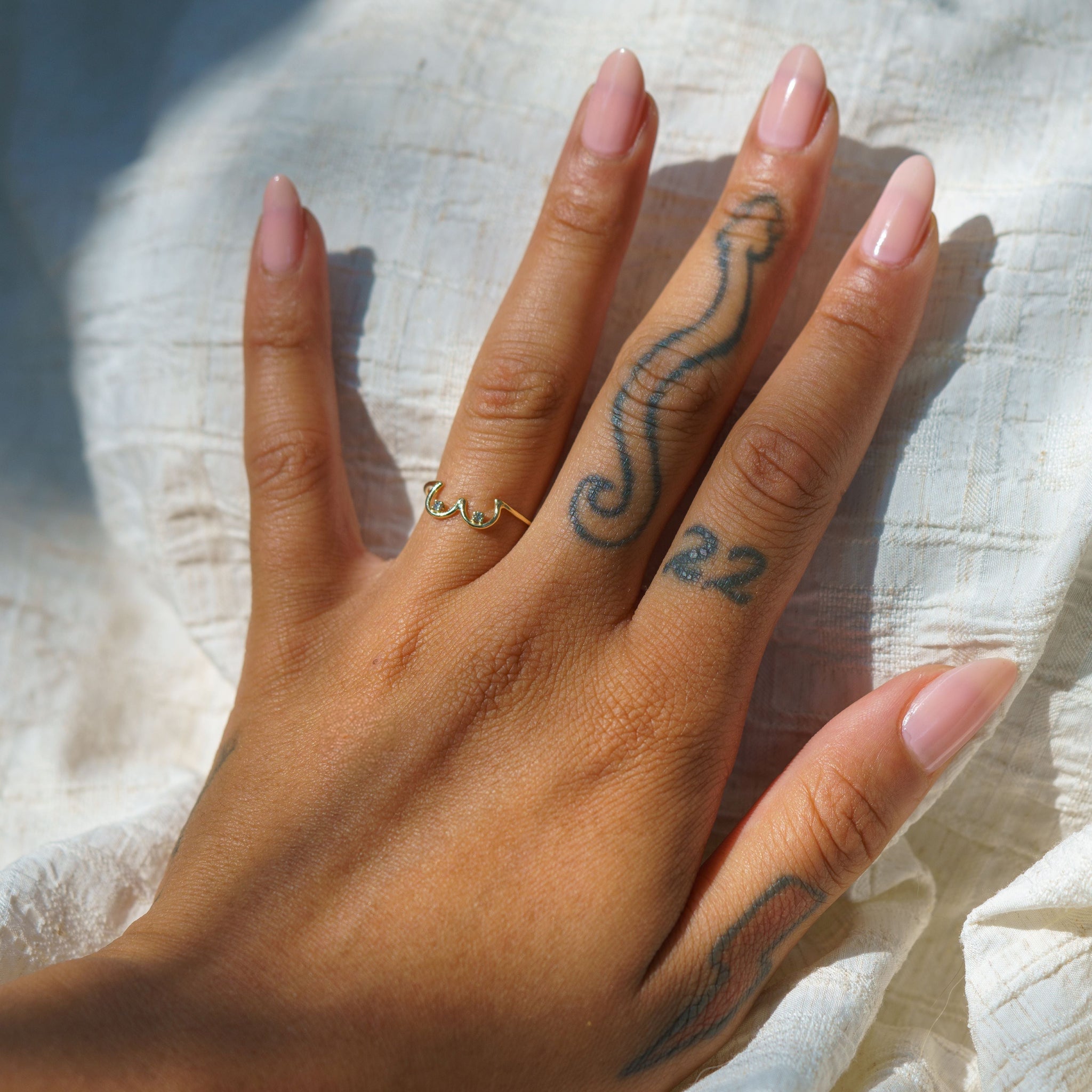 Salt & Pepper Diamond Boob Ring modeled on a hand