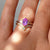Hexagon Cut Pink Sapphire Ring in sunlight on hand