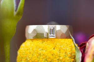 custom sculptural wedding ring in 14k gold with diamond baguette