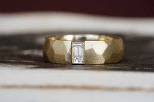 custom sculptural wedding ring in 14k gold with diamond baguette