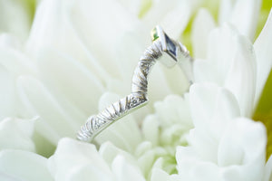 Contour wedding band with round white diamonds and blue sapphire