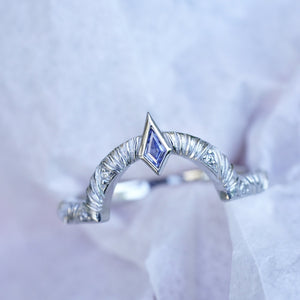 Contour wedding band with round white diamonds and blue sapphire