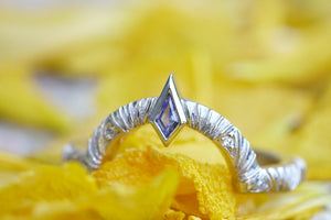 Contour wedding band with round white diamonds and blue sapphire