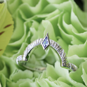 Contour wedding band with round white diamonds and blue sapphire