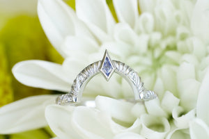 Contour wedding band with round white diamonds and blue sapphire