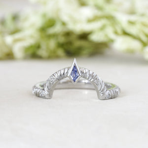 Contour wedding band with round white diamonds and blue sapphire