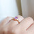 Hexagon Cut Pink Sapphire Ring side view on hand