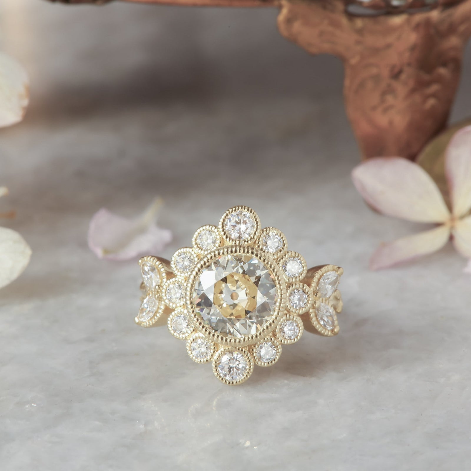 Natural diamond marquise leaves and a graduated diamond halo set in reclaimed 18 karat yellow gold around an antique old European cut diamond. Ready to ship antique inspired flower engagement ring, size 6. 