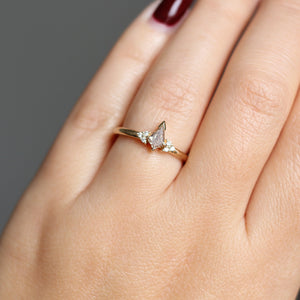 Champagne kite cut diamond ring with white diamond accents, on hand