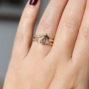 Champagne kite cut diamond ring with white diamond accents and a pointed diamond band, on hand