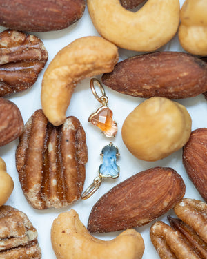 Hermes Charms displayed on a tray of nuts