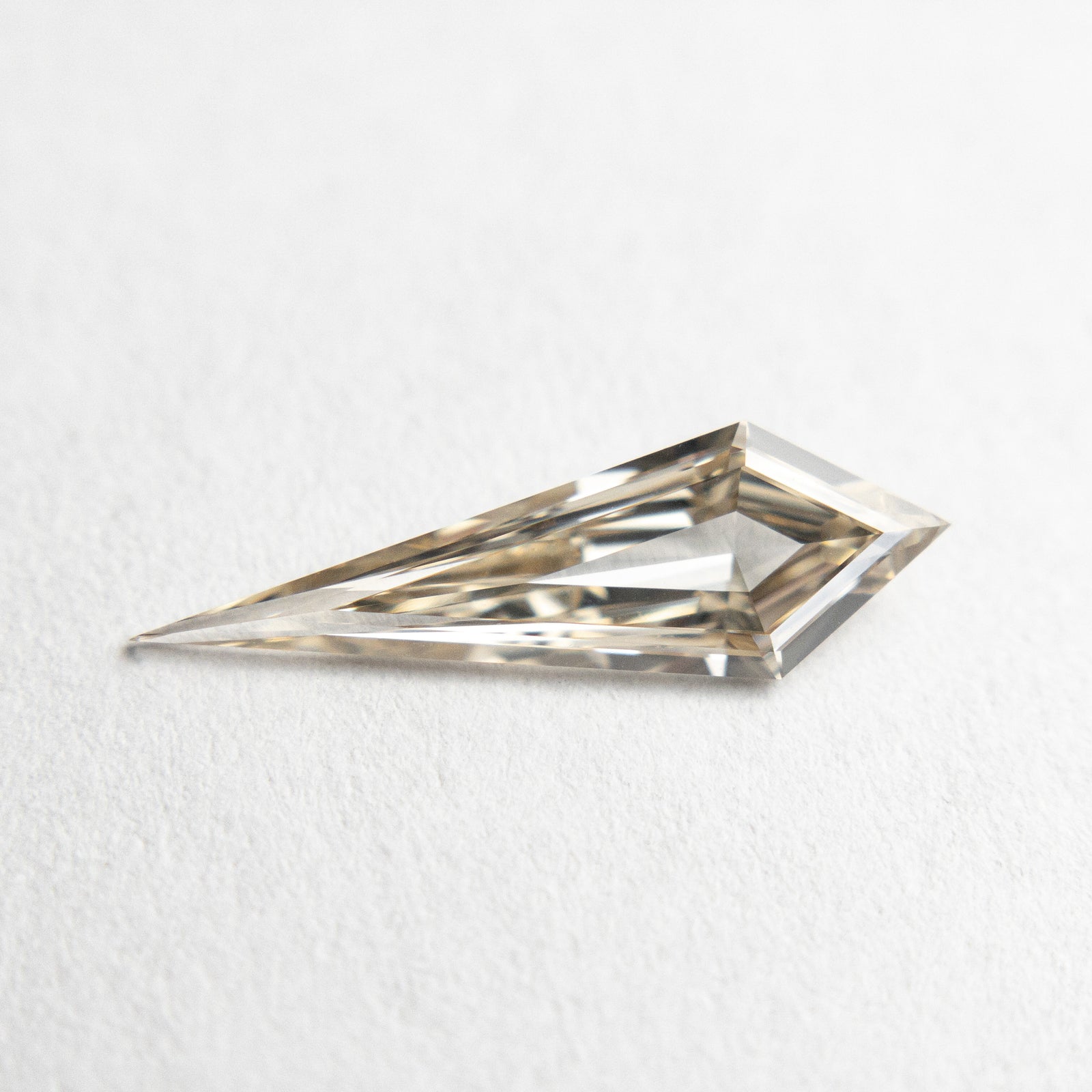 0.58ct 13.83x4.36x1.91mm VS+ Champagne Kite Step Cut 18518-01 - Misfit Diamonds